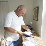 Een man kijkt thuis zijn post door