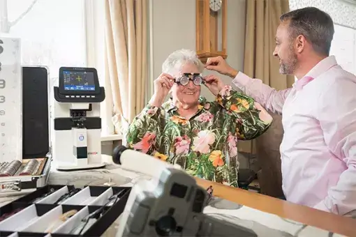 Opticien aan huis bepaalt de brilsterkte bij een oudere mevrouw