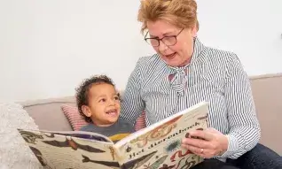 Oma leest kleinkind een boek voor
