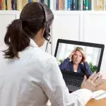 E-health - vrouwelijke arts aan het beeldbellen met patiënt via tablet