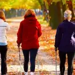 Sport die bij je past - Drie vrouwen doen Nordic walking op herfstige bomenlaan